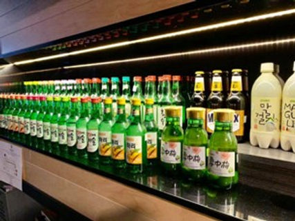 A row of bottles on a shelf Description automatically generated with low confidence